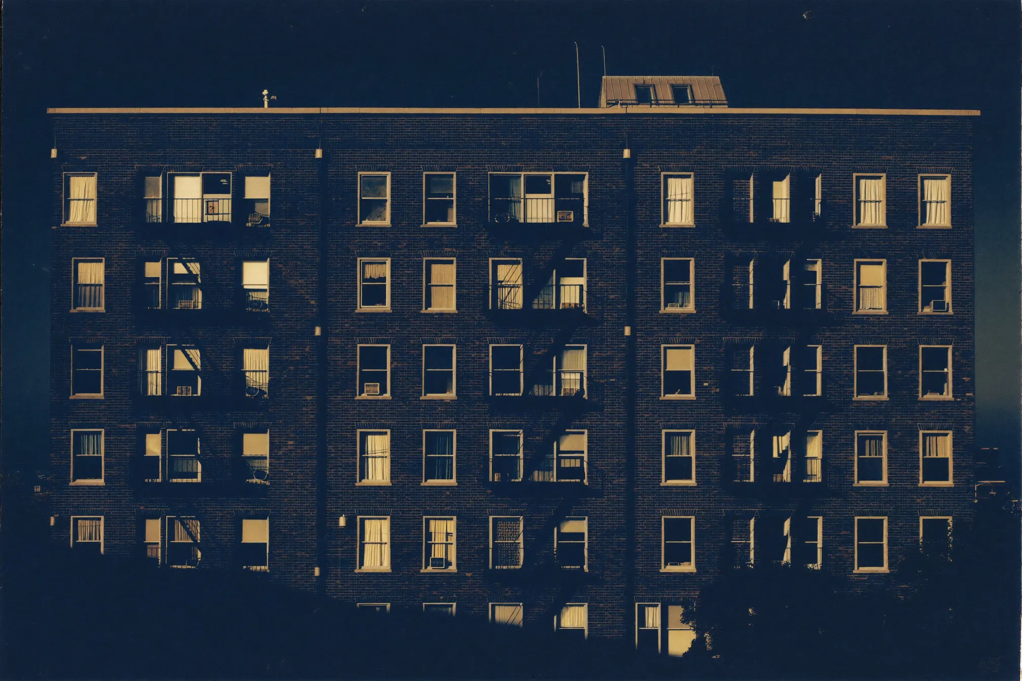 A brick apartment building facade at evening